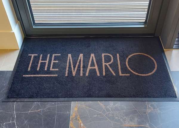 A Carpet Textile Mat with The Marlo logo design