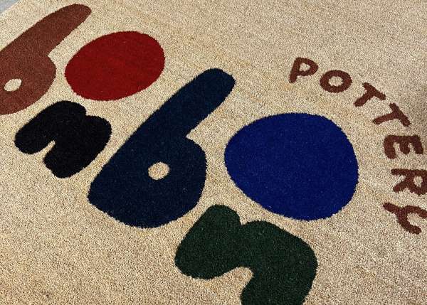 An inlaid Coir Doormat with colourful logo