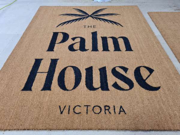 A Coir Logo Mat inlaid with The Palm House Logo